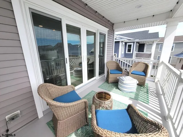 a view of a patio with couches chairs and potted plants