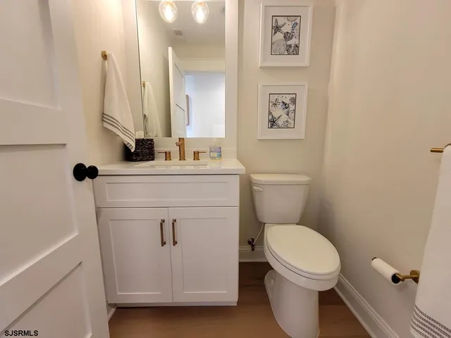 a white toilet sitting next to a bathroom sink