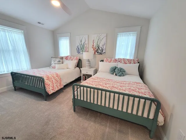 a bedroom with two beds and a table