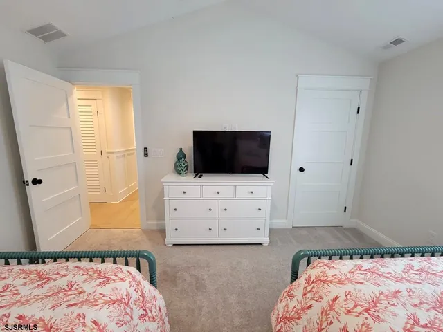 a bedroom with a bed and flat screen tv