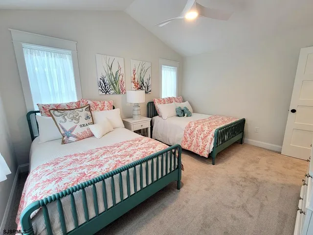 a bedroom with two beds and a chandelier