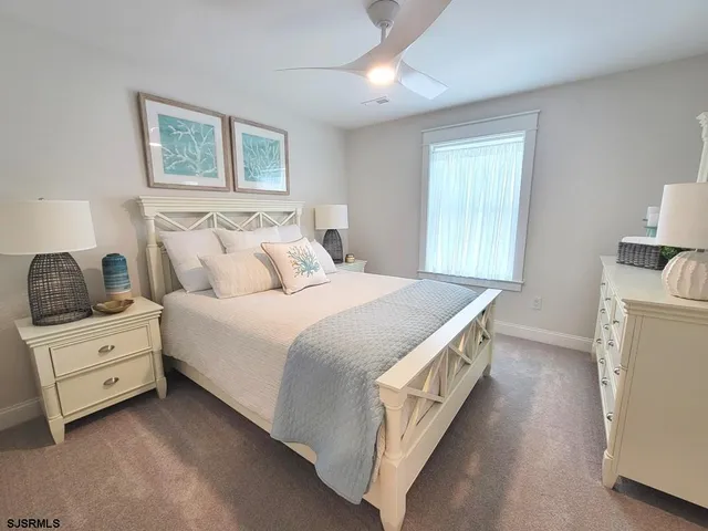 a view of bedroom with natural light and wooden floor