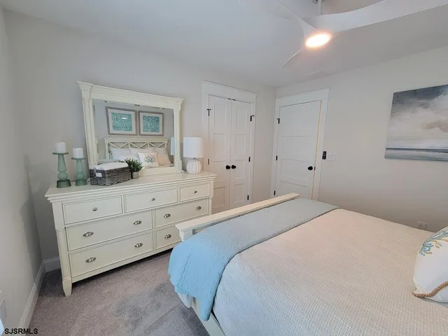 a bedroom with a bed and a dresser