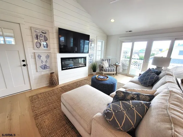 a living room with furniture fireplace and flat screen tv