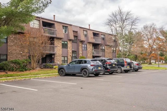 a view of a cars is parked in front of a brick building