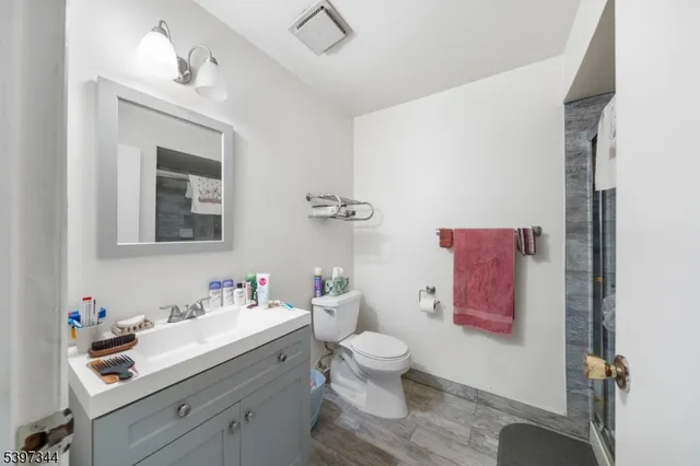 a bathroom with a sink mirror and toilet