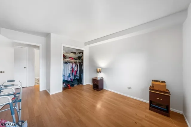 a view of a room with wooden floor and furniture