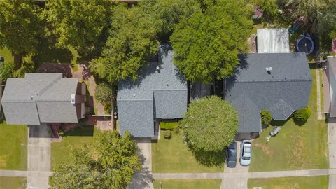 an aerial view of a house with a yard