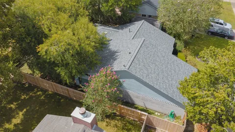 a view of a house with brick walls and a tree