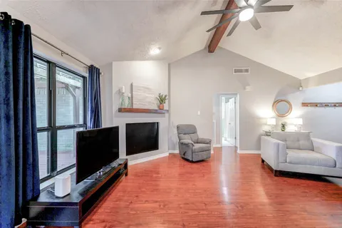 a living room with furniture a table and kitchen view
