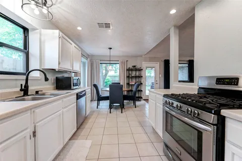 a stove top oven sitting inside of a kitchen