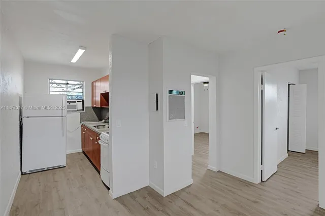 a kitchen with stainless steel appliances a refrigerator and a stove top oven