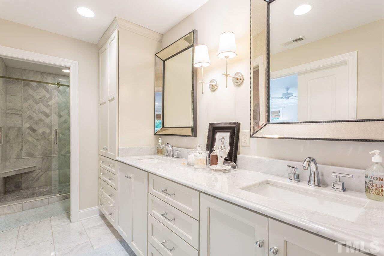 2818 Fowler Avenue Raleigh, NC 27607 - Photo 16 of 25 a bathroom with double sink and a mirror