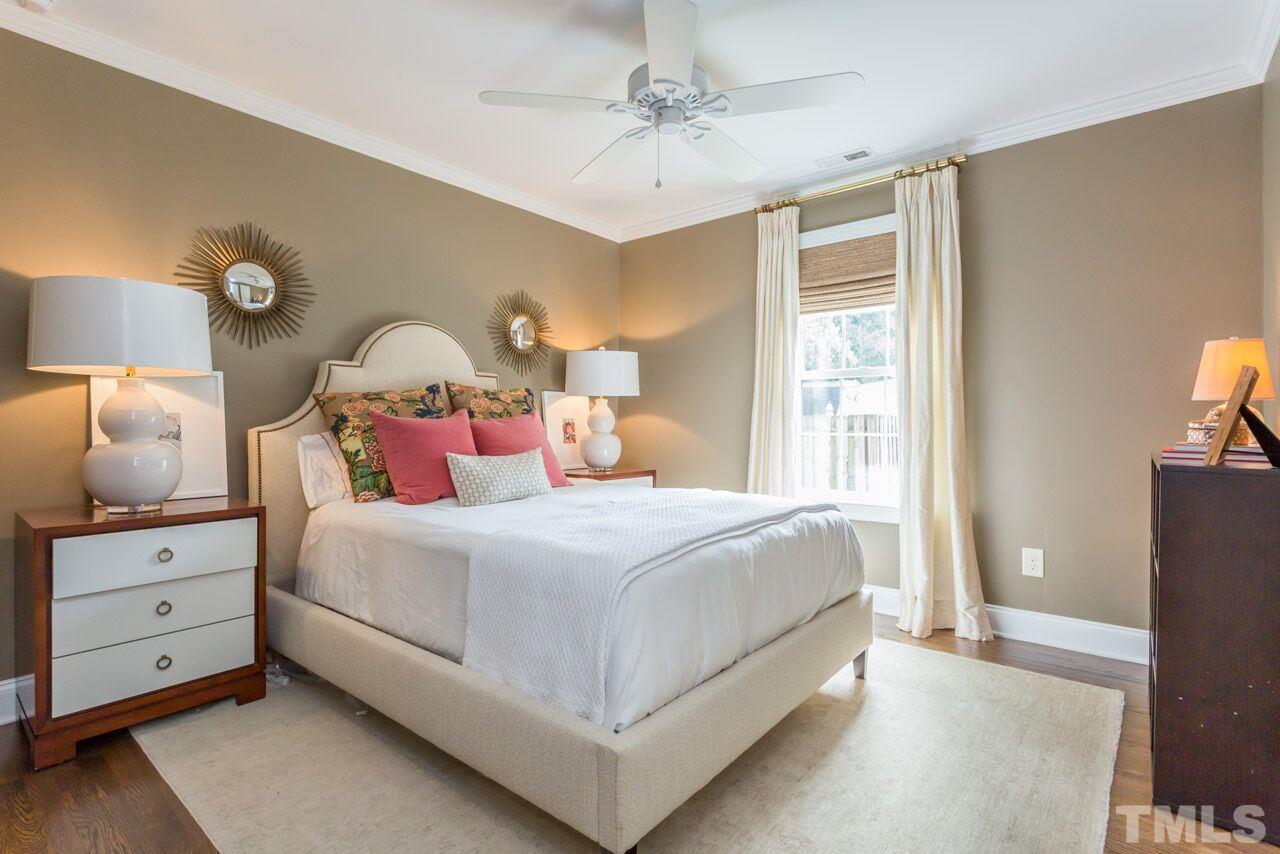 2818 Fowler Avenue Raleigh, NC 27607 - Photo 17 of 25 a bedroom with a bed and a chandelier