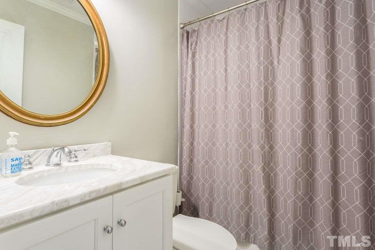 2818 Fowler Avenue Raleigh, NC 27607 - Photo 20 of 25 a bathroom with a sink a toilet and a mirror