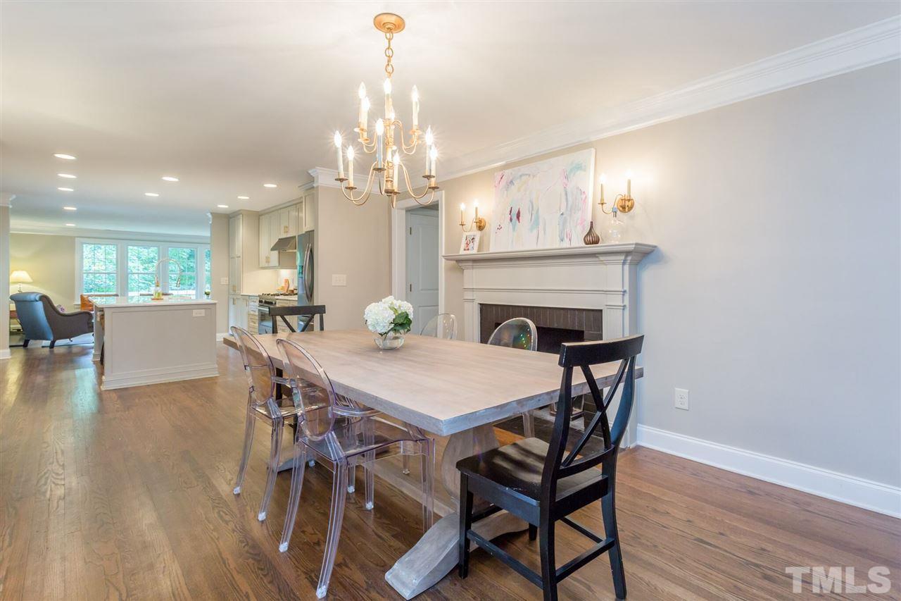 2818 Fowler Avenue Raleigh, NC 27607 - Photo 3 of 25 a view of a dining room with furniture a chandelier and wooden floor