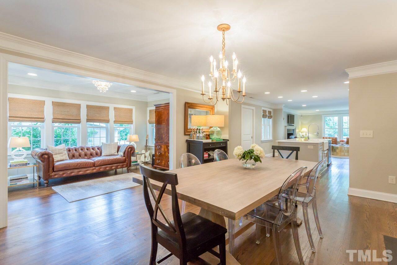 2818 Fowler Avenue Raleigh, NC 27607 - Photo 4 of 25 a view of a dining room with furniture wooden floor and chandelier