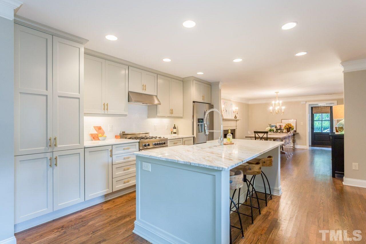 2818 Fowler Avenue Raleigh, NC 27607 - Photo 7 of 25 a kitchen with a sink a stove cabinets and wooden floor