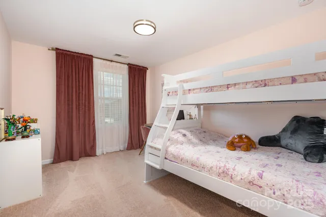 a spacious bedroom with a bed and a window