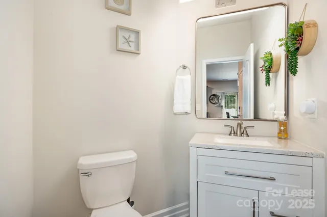 a kitchen with stainless steel appliances kitchen island granite countertop a dining table chairs and refrigerator