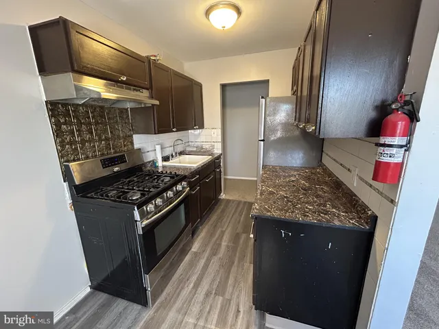 a stove top oven sitting inside of a kitchen