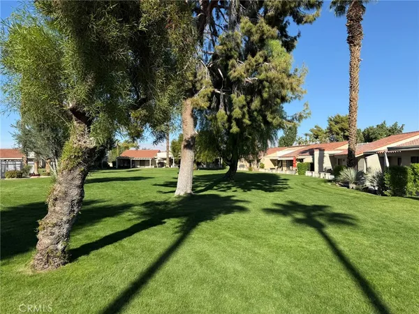 a view of house with a yard