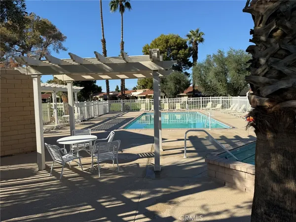 a view of a patio with table and chairs potted plants