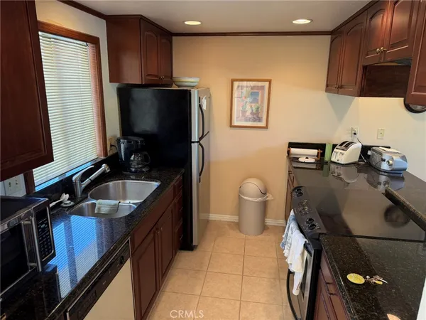 a kitchen with a sink appliances and cabinets