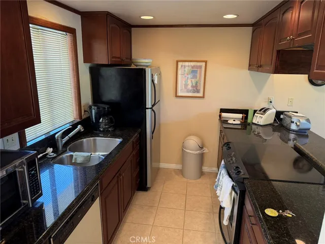 a kitchen with a sink appliances and cabinets