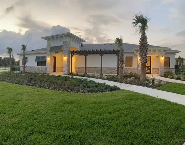 a front view of house with yard and trees