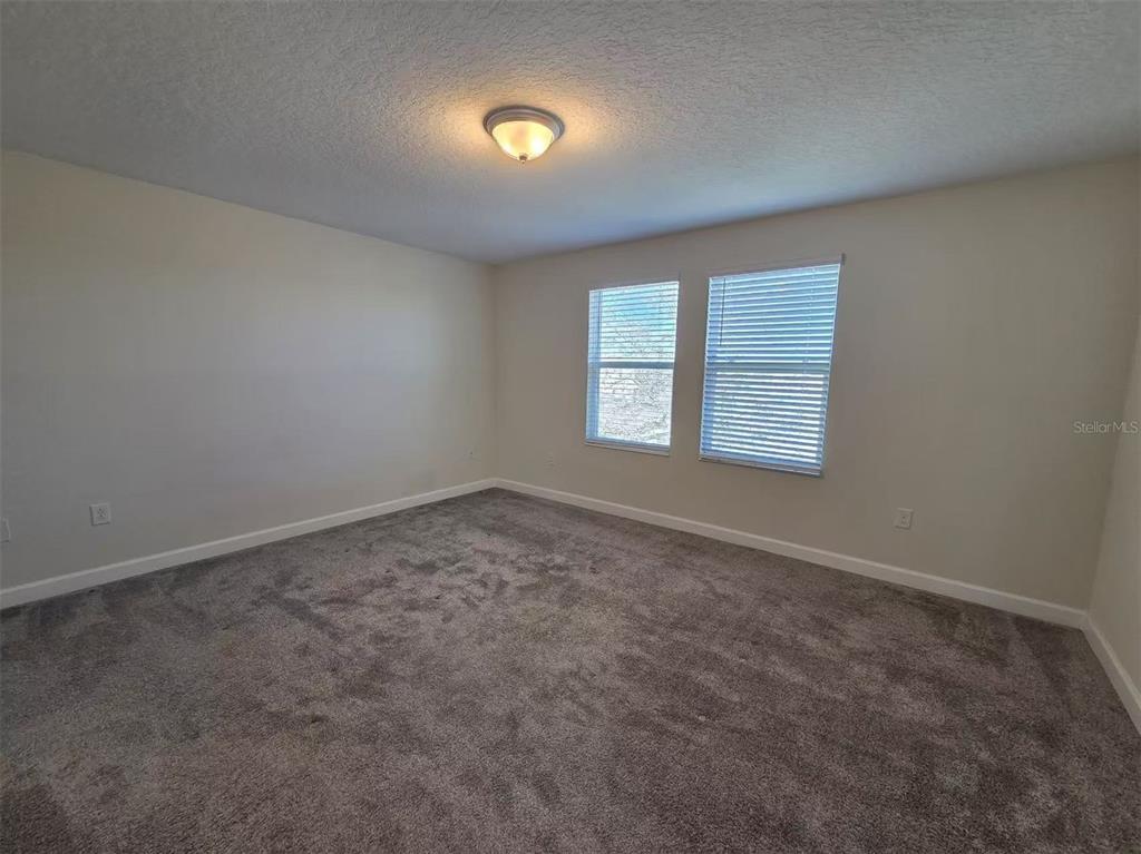 16147 Water Spring Boulevard Winter Garden, FL 34787 - Photo 4 of 17 an empty room with windows