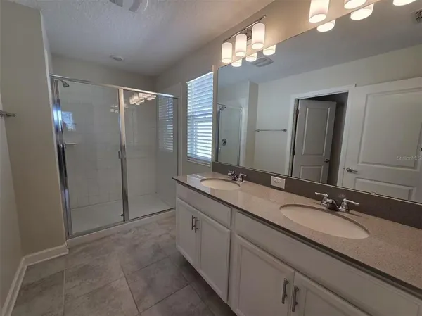a bathroom with a double vanity sink a and a mirror