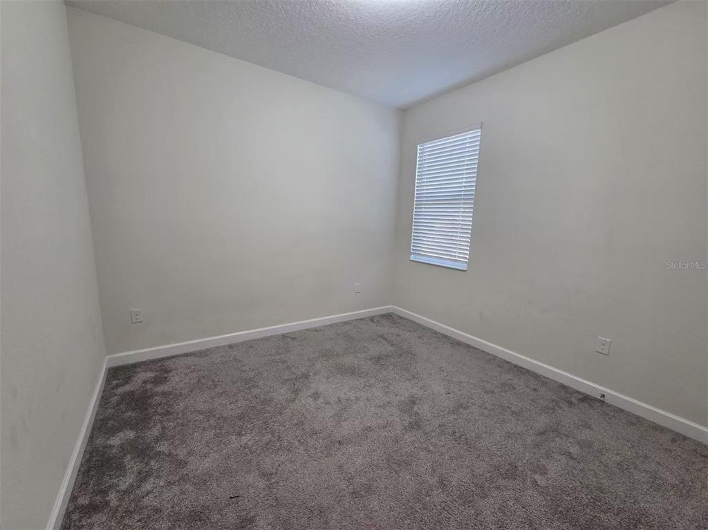 16147 Water Spring Boulevard Winter Garden, FL 34787 - Photo 7 of 17 an empty room with a window