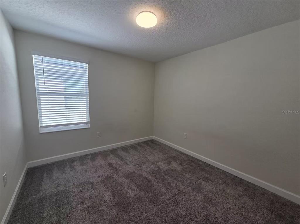 16147 Water Spring Boulevard Winter Garden, FL 34787 - Photo 9 of 17 an empty room with a window
