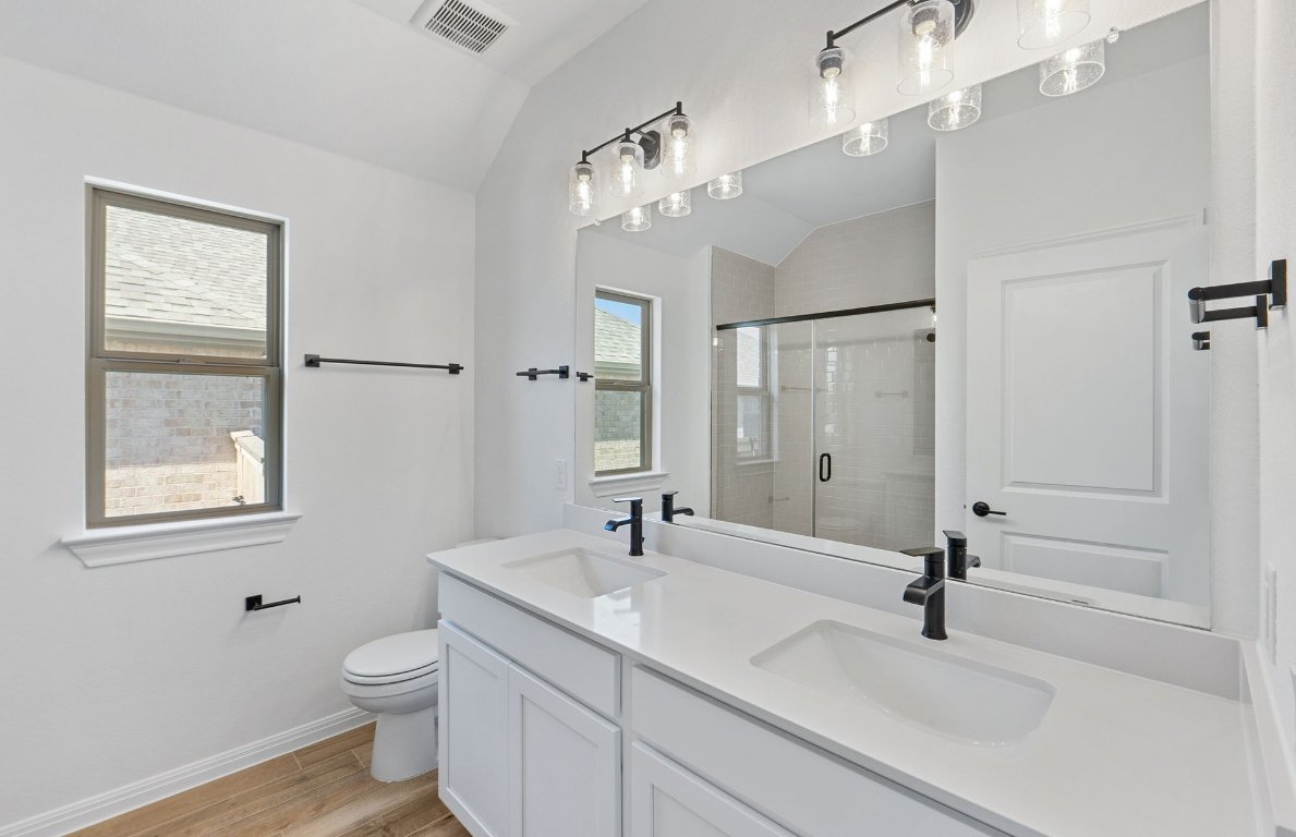 808 Crescent View Drive Georgetown, TX 78628 - Photo 12 of 19 a bathroom with a sink a toilet and a mirror