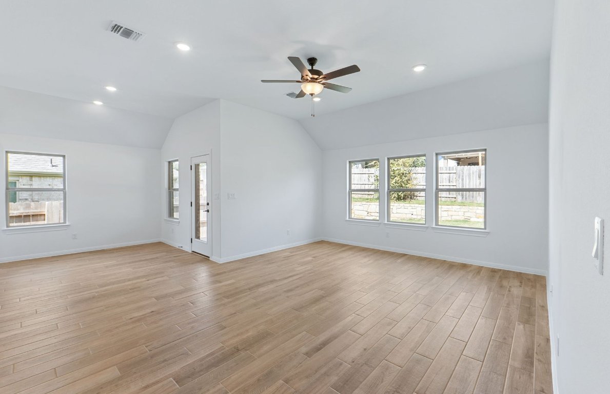 808 Crescent View Drive Georgetown, TX 78628 - Photo 14 of 19 a view of an empty room with a window and wooden floor