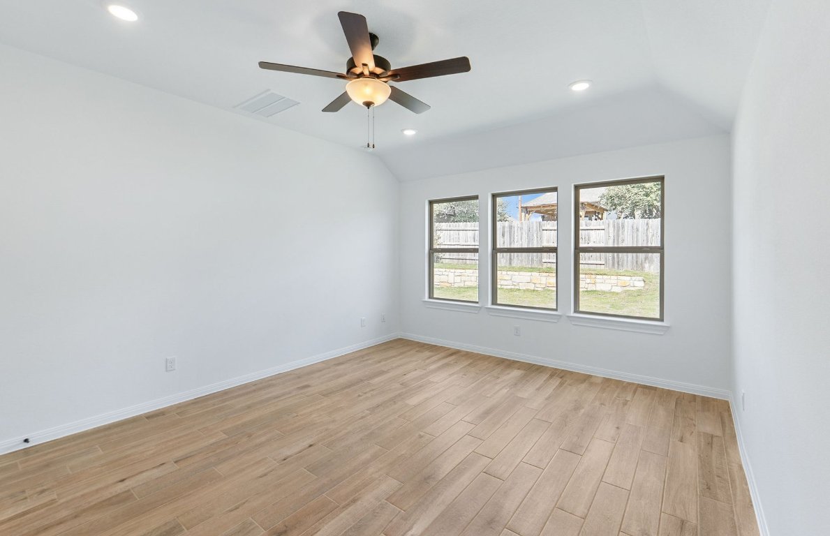 808 Crescent View Drive Georgetown, TX 78628 - Photo 5 of 19 an empty room with wooden floor fan and windows