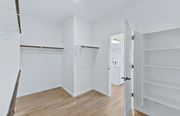 a bathroom with a tub sink double vanity and a mirror