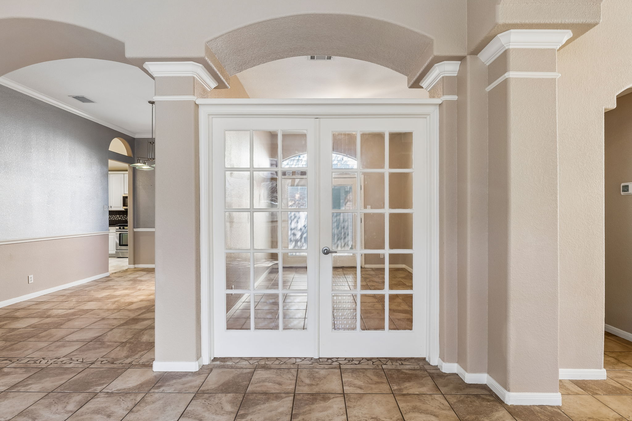 15814 Rustic Lane Austin, TX 78717 - Photo 10 of 29 Elegant architectural arches and classic French doors elevate this tiled entryway.