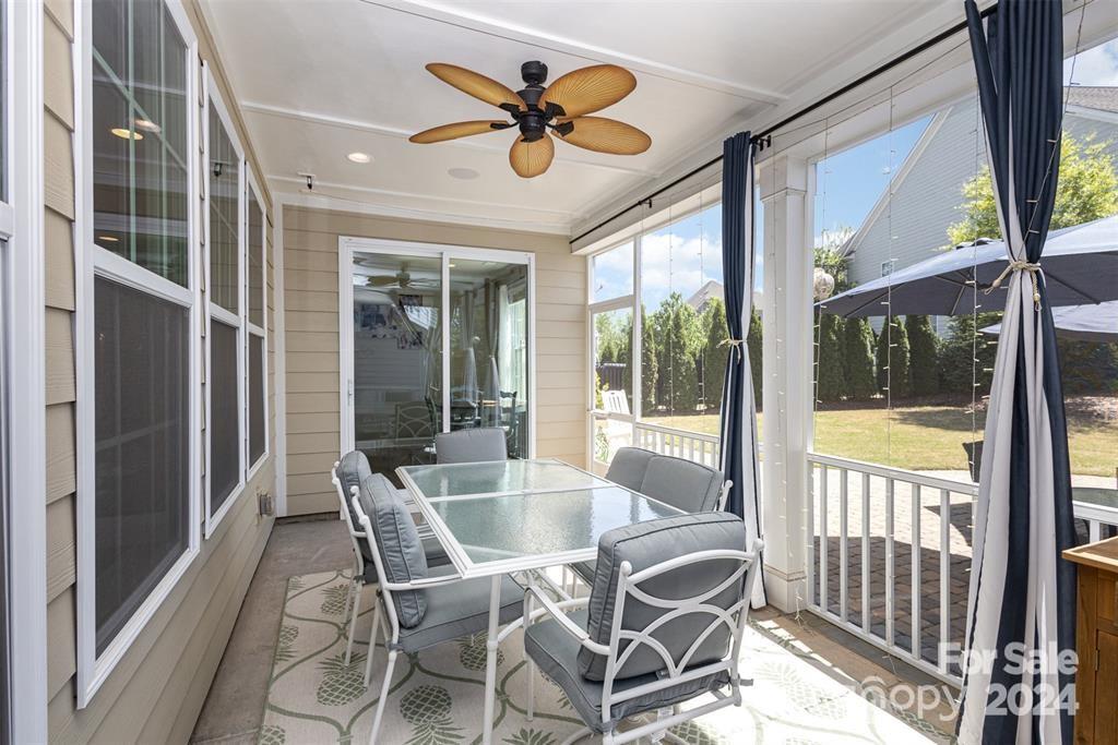 1040 Emory Lane Fort Mill, SC 29708 - Photo 41 of 48 a dining room with furniture a chandelier and a large window