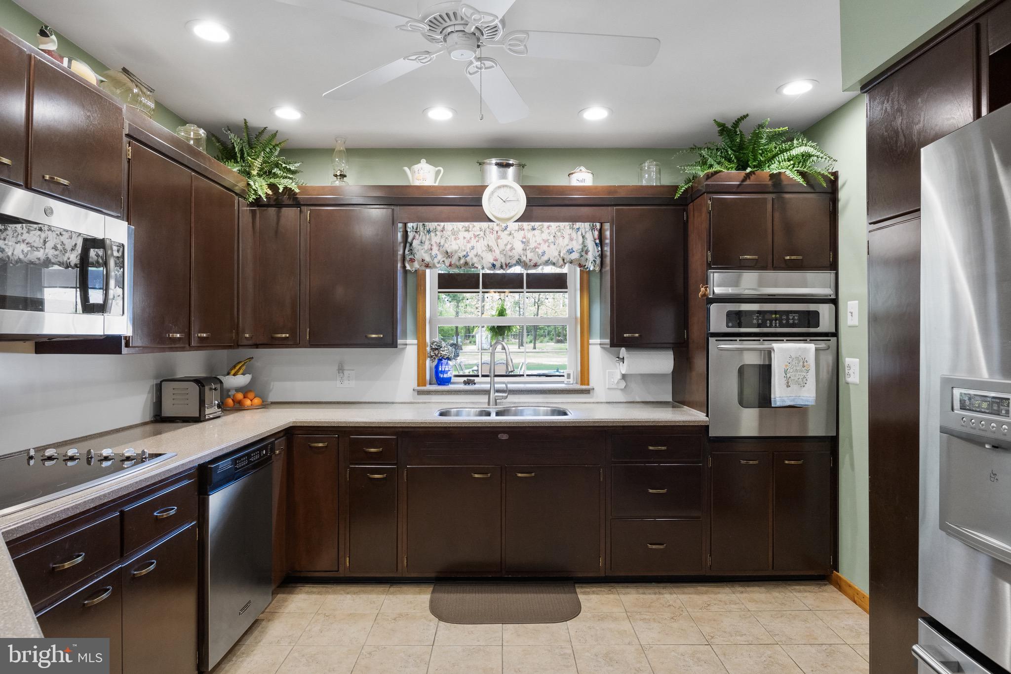 10 Cedar Brook Road Sicklerville, NJ 08081 - Photo 16 of 52 a kitchen with a sink stainless steel appliances and cabinets