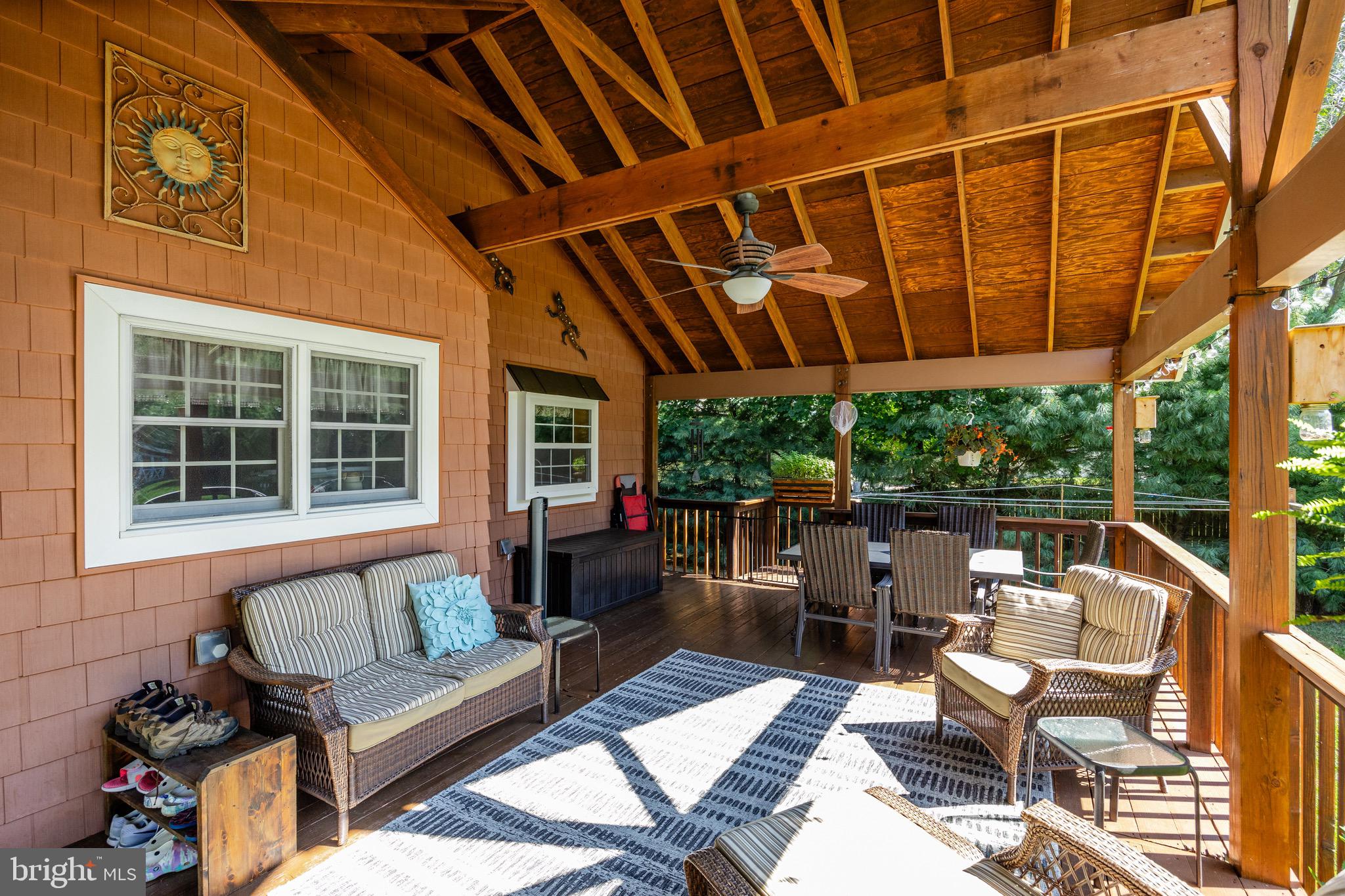 10 Cedar Brook Road Sicklerville, NJ 08081 - Photo 8 of 52 a view of a patio with couches table and chairs under an umbrella with a barbeque