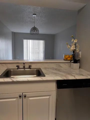 a kitchen with a sink and a window