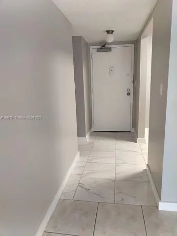 a view of a room with an empty space and a sink