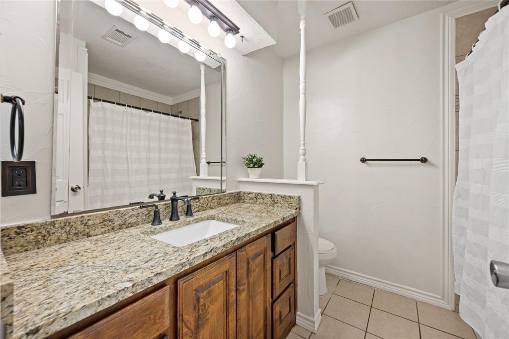 101 Ranch Road Krugerville, TX 76227 - Photo 12 of 39 a bathroom with a granite countertop sink and a mirror