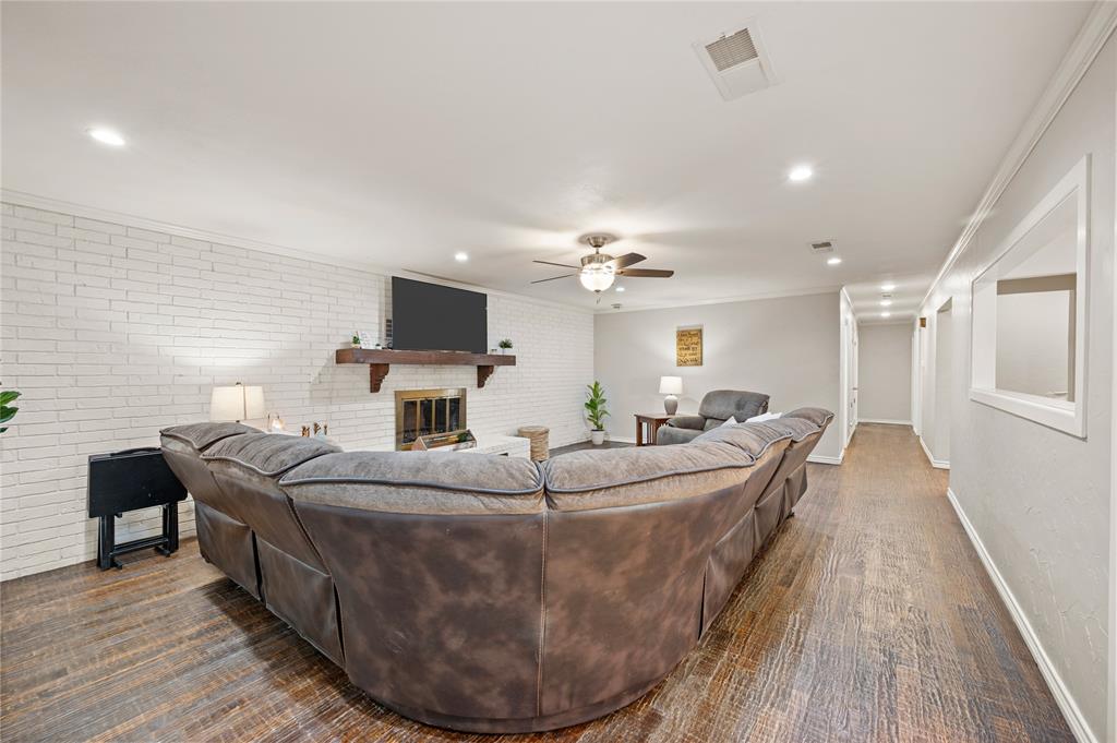 101 Ranch Road Krugerville, TX 76227 - Photo 16 of 39 a living room with fireplace furniture and a wooden floor