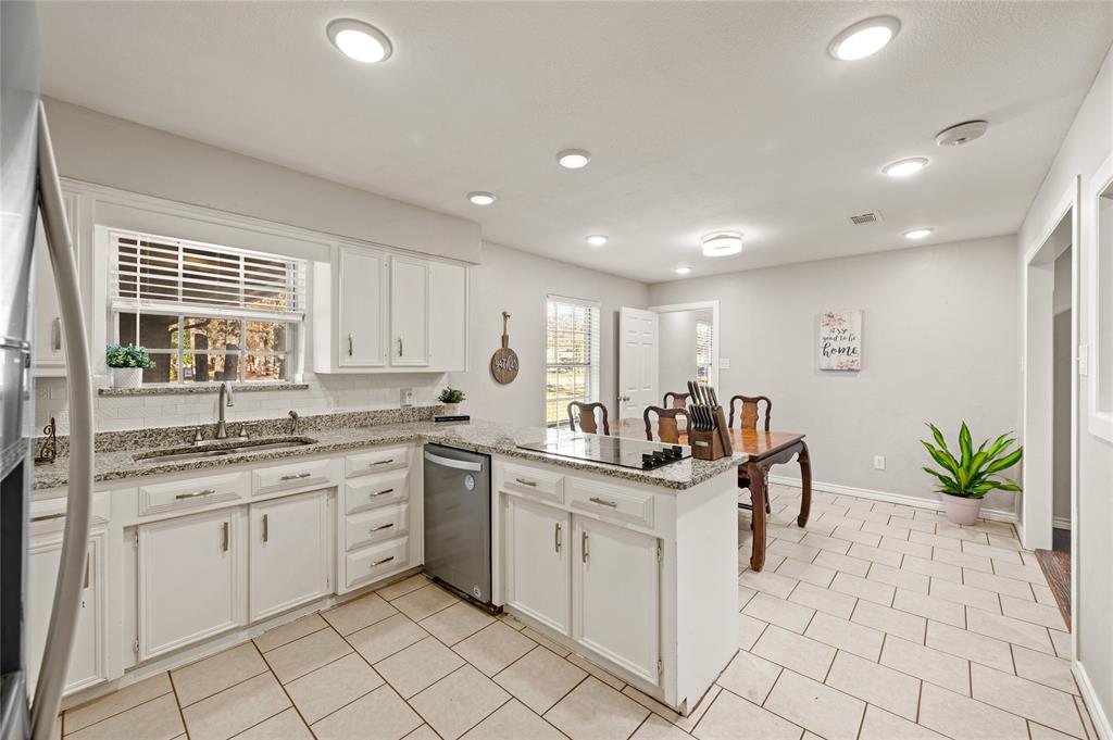 101 Ranch Road Krugerville, TX 76227 - Photo 21 of 39 a kitchen with a sink cabinets and window
