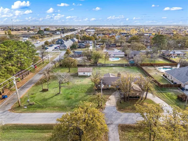 an aerial view of a house with yard swimming pool and outdoor seating