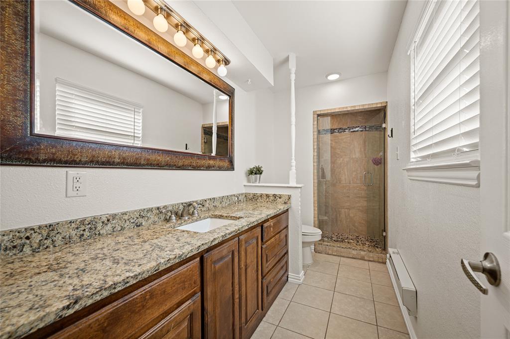 101 Ranch Road Krugerville, TX 76227 - Photo 10 of 39 a bathroom with a granite countertop sink and a mirror