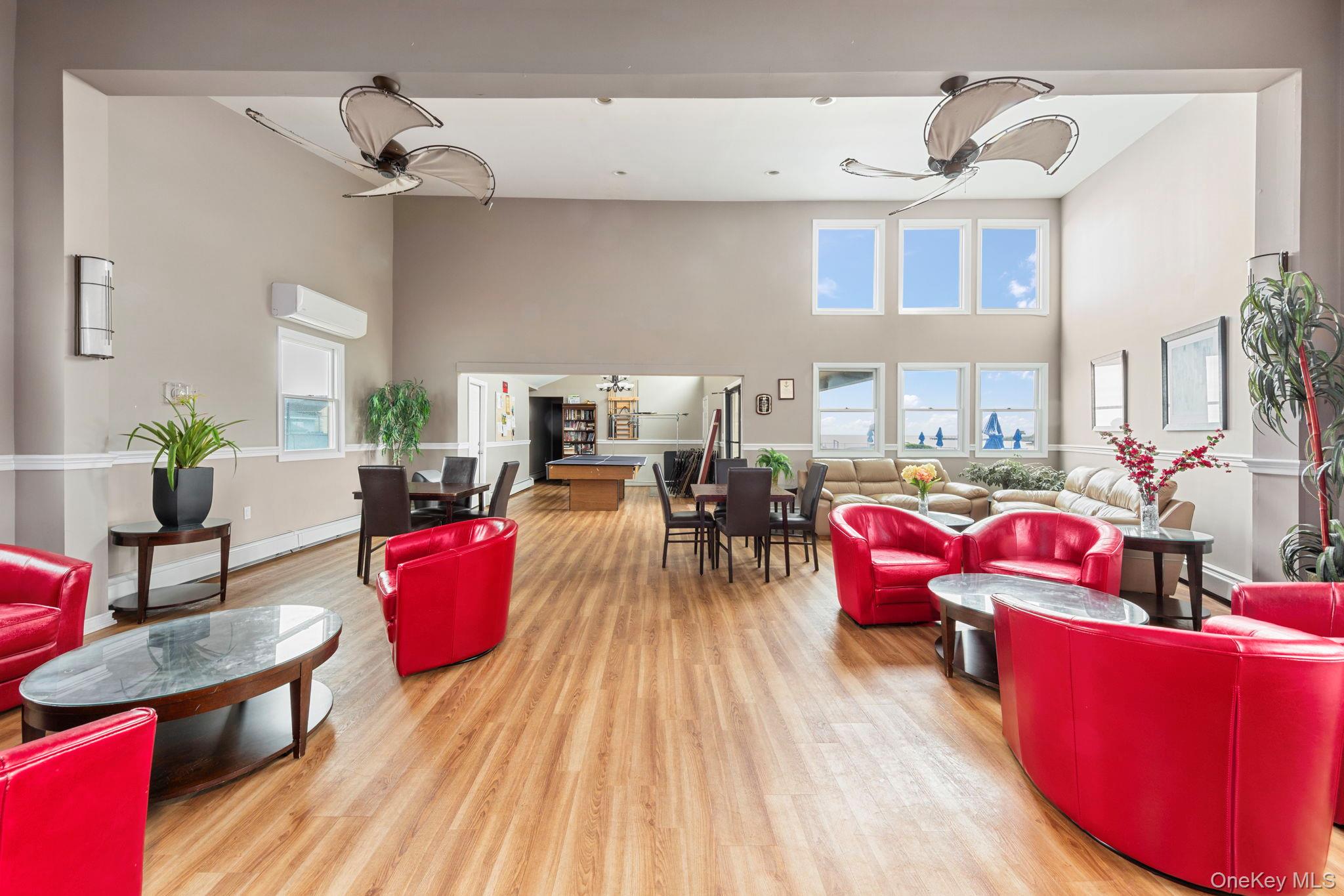 248 Mariners Way Copiague, NY 11726 - Photo 16 of 18 a living room with furniture windows and a wooden floor